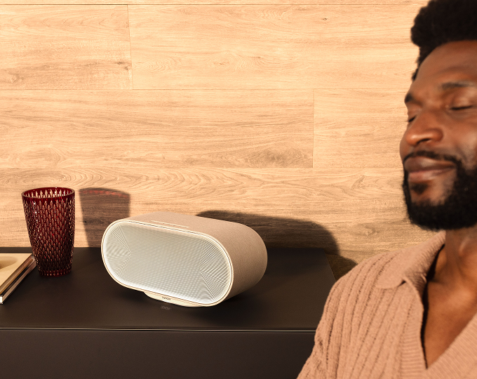 Denon Home 600 wireless speaker in white on a cabinet in a home setting